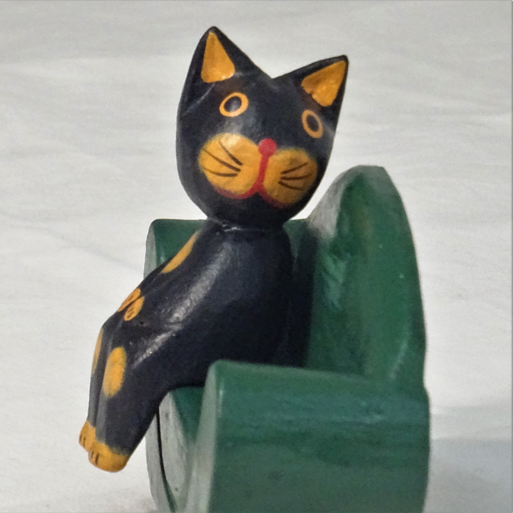 Canoodling Cats on a Green Sofa