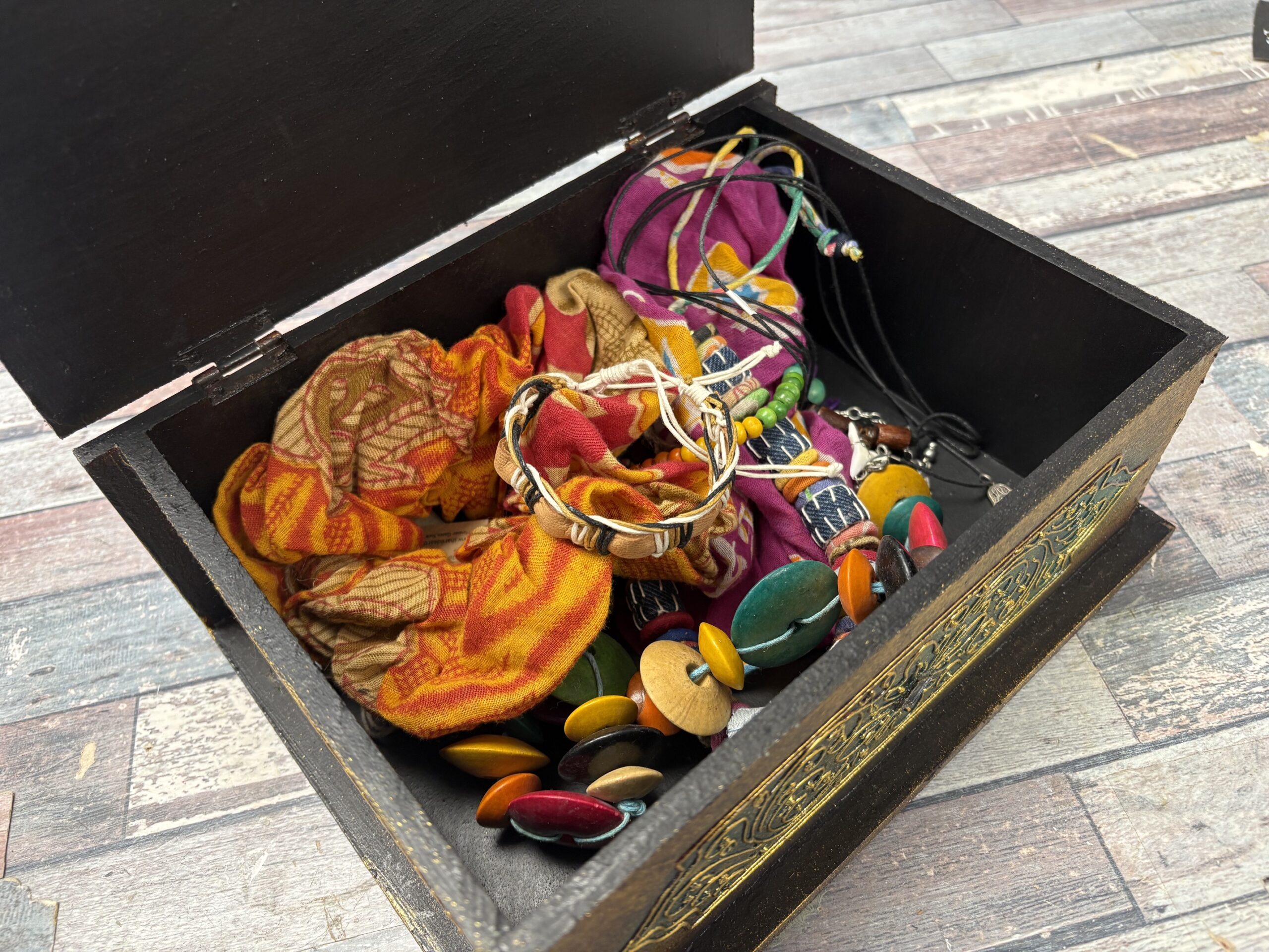 A Golden Buddha Jewellery Box with fashion accessories and jewellery inside