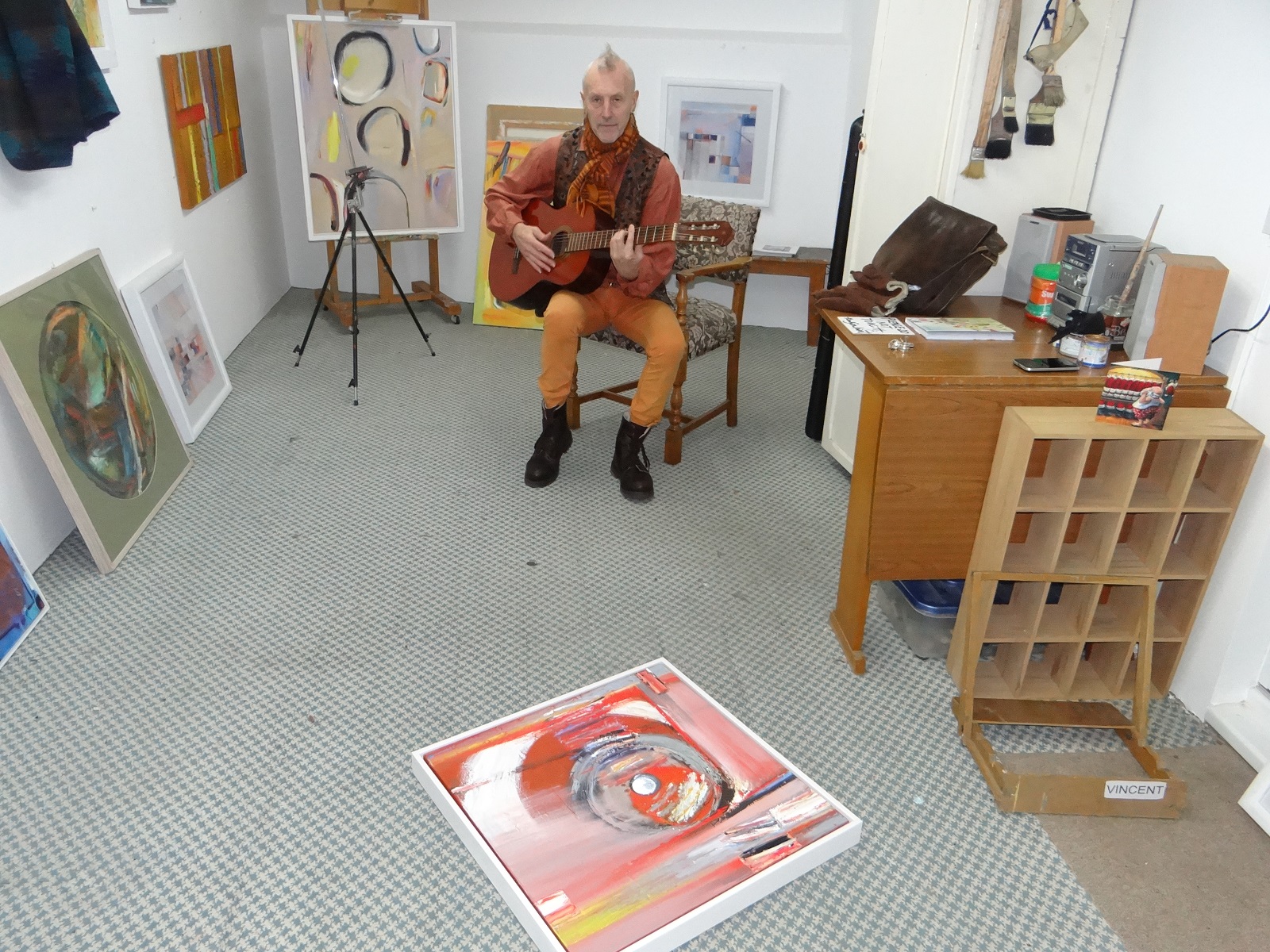 Vincent playing his guitar in his Teignmouth Art Studio